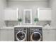 Laundry room with modern washer and dryer, and ample counter space at 506 Yellow Submarine Ct, Groveland, FL 34737