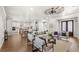 Open living space with hardwood floors, a fireplace, and large windows at 506 Yellow Submarine Ct, Groveland, FL 34737