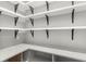 Organized pantry featuring white shelving with black brackets and light countertops; efficient storage space at 506 Yellow Submarine Ct, Groveland, FL 34737