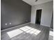 Comfortable bedroom features stylish floors, a dark accent wall, and natural lighting at 5518 Metrowest Blvd # 104, Orlando, FL 32811