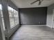 Bedroom with large window with modern floors and neutral paint at 5518 Metrowest Blvd # 104, Orlando, FL 32811