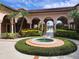 Picturesque clubhouse courtyard with a charming water fountain and decorative landscaping at 5518 Metrowest Blvd # 104, Orlando, FL 32811