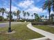 Well-maintained community grounds with lush landscaping, sidewalks, and mature palm trees at 5518 Metrowest Blvd # 104, Orlando, FL 32811