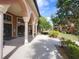 Inviting entrance with stucco arches, mature landscaping, and walkway in a well-maintained community at 5518 Metrowest Blvd # 104, Orlando, FL 32811