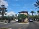 The community entry gate welcomes residents home with lush landscaping and gated entry at 5518 Metrowest Blvd # 104, Orlando, FL 32811