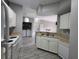 Kitchen with appliances, plenty of cabinets, and a breakfast bar open to the main living area at 5518 Metrowest Blvd # 104, Orlando, FL 32811