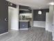 Open living area with modern flooring, neutral paint, and a view into the kitchen at 5518 Metrowest Blvd # 104, Orlando, FL 32811