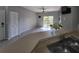 Open-concept living area with modern flooring and sliding glass doors for outdoor access at 5518 Metrowest Blvd # 104, Orlando, FL 32811