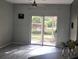 Living room featuring sliding glass doors leading to an outdoor area with a ceiling fan at 5518 Metrowest Blvd # 104, Orlando, FL 32811