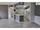 Open living space with modern flooring, neutral paint, and a view into the kitchen at 5518 Metrowest Blvd # 104, Orlando, FL 32811