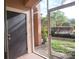 Enclosed back patio with view of lawn area, trees and glimpses of the Community Pool area at 5518 Metrowest Blvd # 104, Orlando, FL 32811
