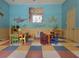 Bright, colorful room with playful decor, tables and chairs for activities at 5518 Metrowest Blvd # 104, Orlando, FL 32811