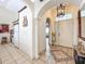 Inviting foyer showcasing tile flooring, decorative arches, and a charming chandelier at 617 Villa Ct # 617, Clermont, FL 34711