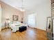 Cozy main bedroom featuring hardwood floors, a ceiling fan, and ample natural light at 617 Villa Ct # 617, Clermont, FL 34711