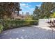 A spacious outdoor brick paver patio with mature trees and privacy landscaping for enjoying the outdoors at 7189 Regina Way, Orlando, FL 32819
