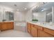 Bright bathroom featuring dual sinks, a soaking tub, and tile flooring at 7189 Regina Way, Orlando, FL 32819