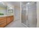 Bathroom with walk-in shower, natural wood vanity, light tile floor and plenty of space at 7189 Regina Way, Orlando, FL 32819