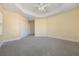 Spacious bedroom featuring plush carpeting, a ceiling fan, and a double door closet at 7189 Regina Way, Orlando, FL 32819