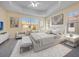 A sun-drenched primary bedroom with white furniture and a ceiling fan at 7189 Regina Way, Orlando, FL 32819