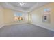 Spacious bedroom with carpet flooring, ceiling fan, and natural light at 7189 Regina Way, Orlando, FL 32819