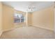 Bedroom featuring a ceiling fan, plush carpet, and a window for natural light at 7189 Regina Way, Orlando, FL 32819