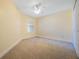 Bedroom featuring plush carpet, a ceiling fan, and a window for natural light at 7189 Regina Way, Orlando, FL 32819