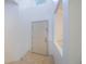 Bright white entryway with tiled floors leading to a classic six-panel door at 7189 Regina Way, Orlando, FL 32819