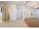 Inviting entryway with tile flooring leading to carpeted dining area and white walls at 7189 Regina Way, Orlando, FL 32819