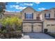 Charming townhome with a red tile roof, stone accents, and two-car garage at 7189 Regina Way, Orlando, FL 32819