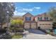 Charming townhome featuring a two-car garage, stone accents and a well manicured lawn at 7189 Regina Way, Orlando, FL 32819