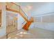 Bright foyer features a staircase with wood railings, light tile flooring, and high ceilings at 7189 Regina Way, Orlando, FL 32819
