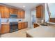 Modern kitchen with sleek appliances, countertops, and ample cabinet space at 7189 Regina Way, Orlando, FL 32819