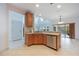 Kitchen featuring stainless steel appliances, breakfast bar, tile flooring, and modern lighting at 7189 Regina Way, Orlando, FL 32819