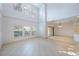 Spacious living room with high ceilings, tiled floors, and multiple windows at 7189 Regina Way, Orlando, FL 32819