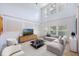 Bright living room featuring a high ceiling, large windows, and contemporary furniture at 7189 Regina Way, Orlando, FL 32819