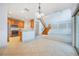 Open concept living room with kitchen, high ceilings, and a wooden staircase at 7189 Regina Way, Orlando, FL 32819