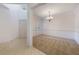 Bright living room with neutral carpet, trim, and a chandelier at 7189 Regina Way, Orlando, FL 32819