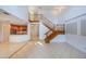 Grand living area with a staircase, a view of the modern kitchen, and lots of natural light at 7189 Regina Way, Orlando, FL 32819