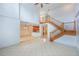 Open concept living room with wooden staircase, light tile floors, and high ceilings at 7189 Regina Way, Orlando, FL 32819