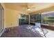 A spacious screened-in lanai features brick pavers and a ceiling fan for outdoor relaxation at 7189 Regina Way, Orlando, FL 32819