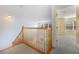 Upstairs landing with wooden railing and carpeted floors at 7189 Regina Way, Orlando, FL 32819
