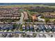 Beautiful aerial view of a vibrant community with well-maintained homes, lush landscaping, and serene natural surroundings at 7343 Oakmoss Loop, Davenport, FL 33837