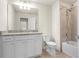 Bathroom with large mirror, vanity, toilet, and shower at 7343 Oakmoss Loop, Davenport, FL 33837