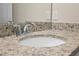 Bathroom vanity with granite countertop and chrome faucet with a sink at 7343 Oakmoss Loop, Davenport, FL 33837