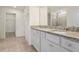 Bright bathroom with granite countertop and white cabinetry at 7343 Oakmoss Loop, Davenport, FL 33837