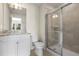 Bathroom featuring a granite vanity, toilet, and glass shower at 7343 Oakmoss Loop, Davenport, FL 33837