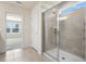 Modern bathroom featuring glass-enclosed shower and natural light at 7343 Oakmoss Loop, Davenport, FL 33837