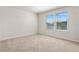 Well-lit bedroom with neutral carpet and large windows allowing for abundant natural light at 7343 Oakmoss Loop, Davenport, FL 33837