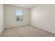 Bedroom with neutral carpet and window with blinds at 7343 Oakmoss Loop, Davenport, FL 33837