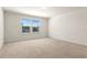 Spacious bedroom featuring neutral carpet and a double window for ample natural light at 7343 Oakmoss Loop, Davenport, FL 33837